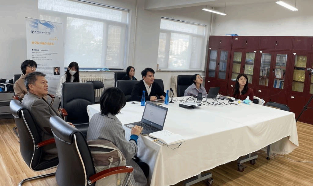 a group of people sitting around a tabledescription automatically generated with medium confidence